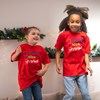 Children smiling and  wearing naughty nice t-shirt 